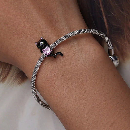 Black cat charm bracelet with enamel detail and cubic zirconia, crafted in sterling silver with black gold plating for Halloween style
