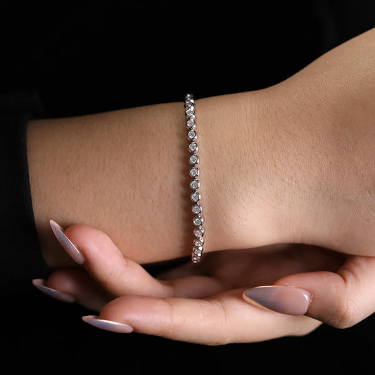 Round Moissanite Minimalist Bracelet in 925 sterling silver with 18K white gold plating, featuring bezel-set 2.5mm moissanites for a sleek, refined look.