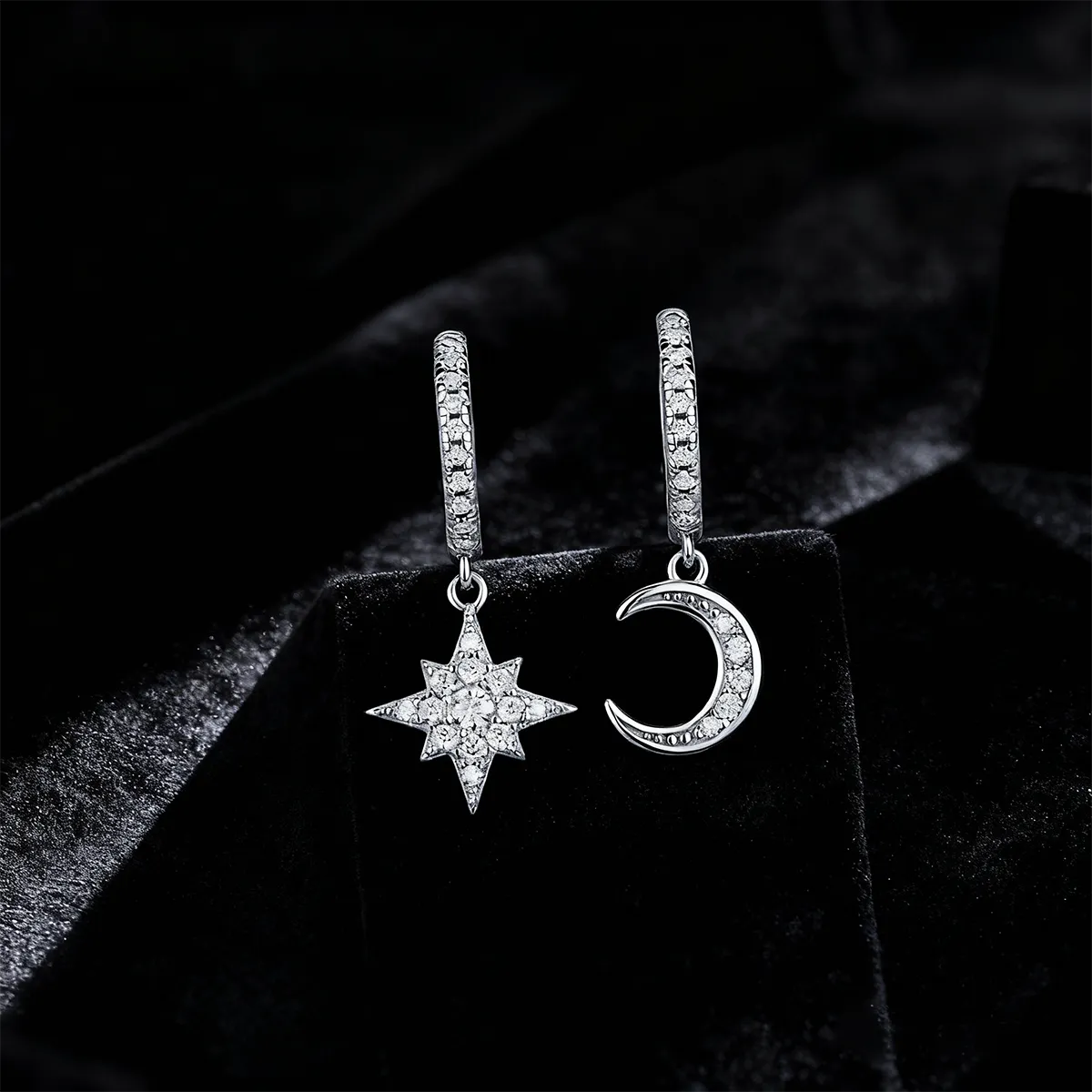 Pavé moon and star asymmetric drop hoop earrings, 925 sterling silver with 18K white gold plating, featuring 38 moissanite stones.