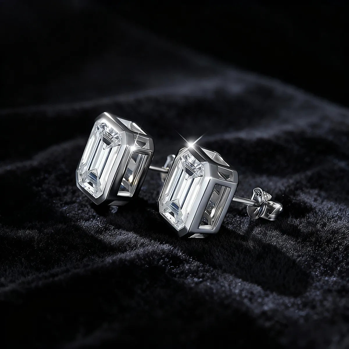 Emerald-cut 10×8mm moissanite solitaire stud earrings, 925 sterling silver with 18K white gold plating and octagon bezel setting.