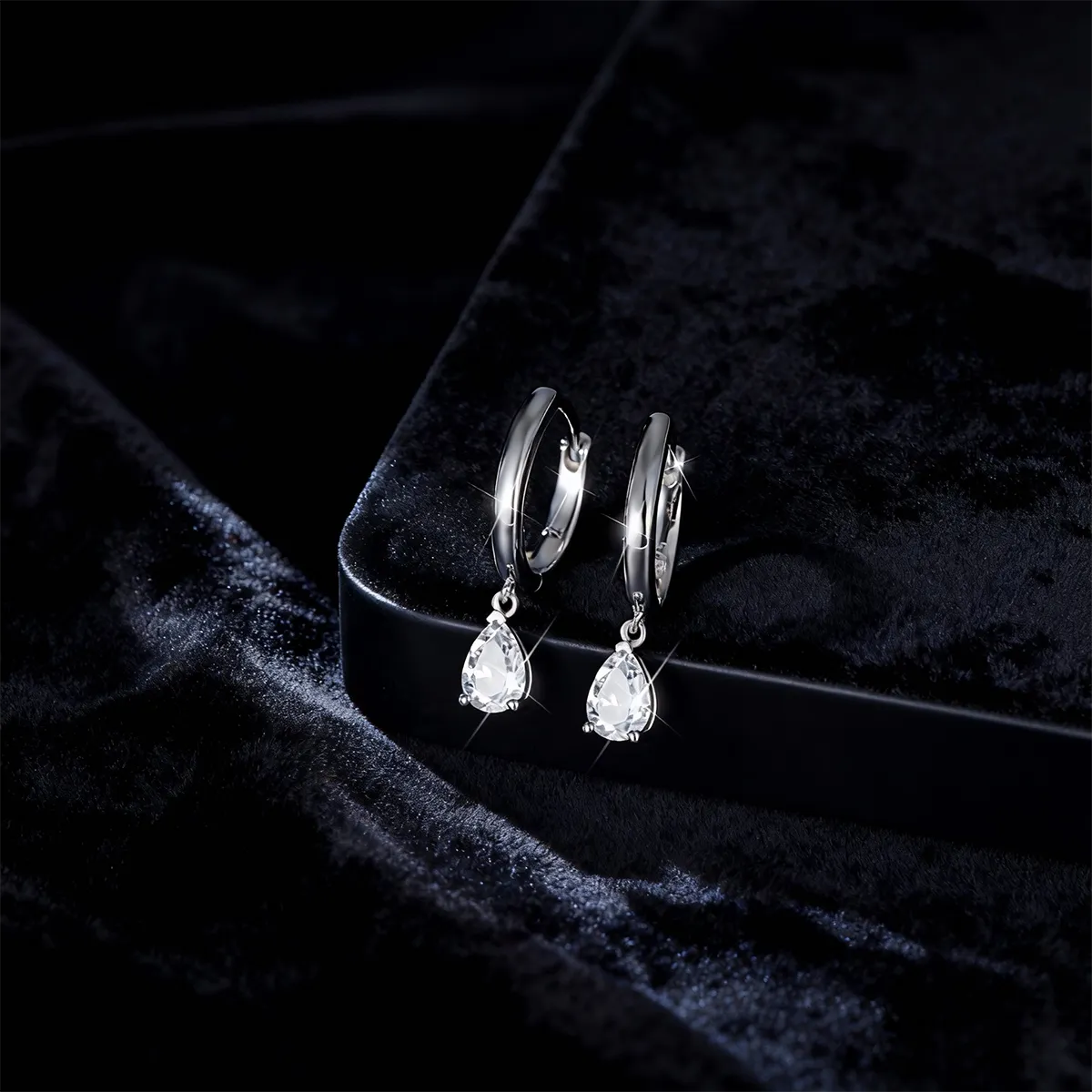 Minimalist slim sterling silver hoop earrings with 6x4mm pear-shaped moissanite teardrop charms.