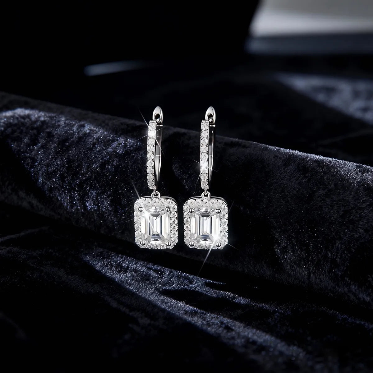 Asymmetric sterling silver bar drop earrings with halo-set baguette stones and pear-cut moissanite accents.