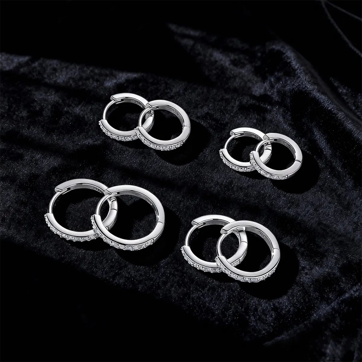 Minimalist sterling silver earrings featuring a slim pavé moissanite bar paired with a half-pavé huggie hoop, offering lightweight, low-profile daily wear.