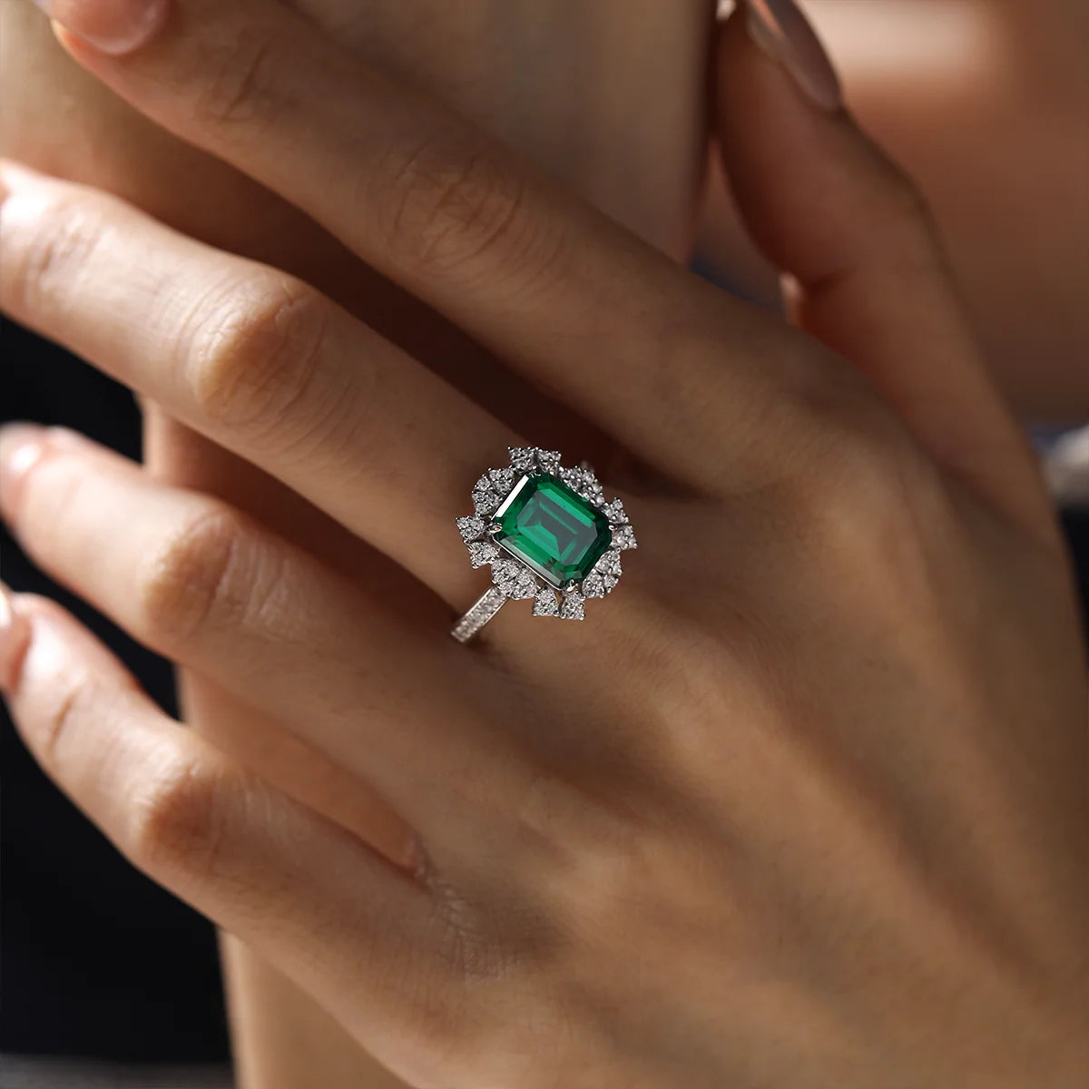 A 5.5ct emerald-cut green YAG gemstone set in white-gold-plated sterling silver, accented by white cubic zirconia that resemble delicate blooming petals.