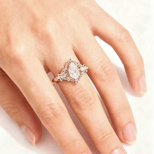 Victorian style rose gold cluster ring with pear cut center diamond and pear accents