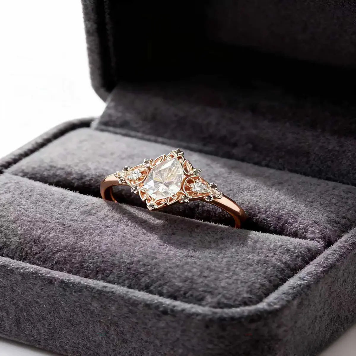 Victorian style rose gold cluster ring with pear cut center diamond and pear accents