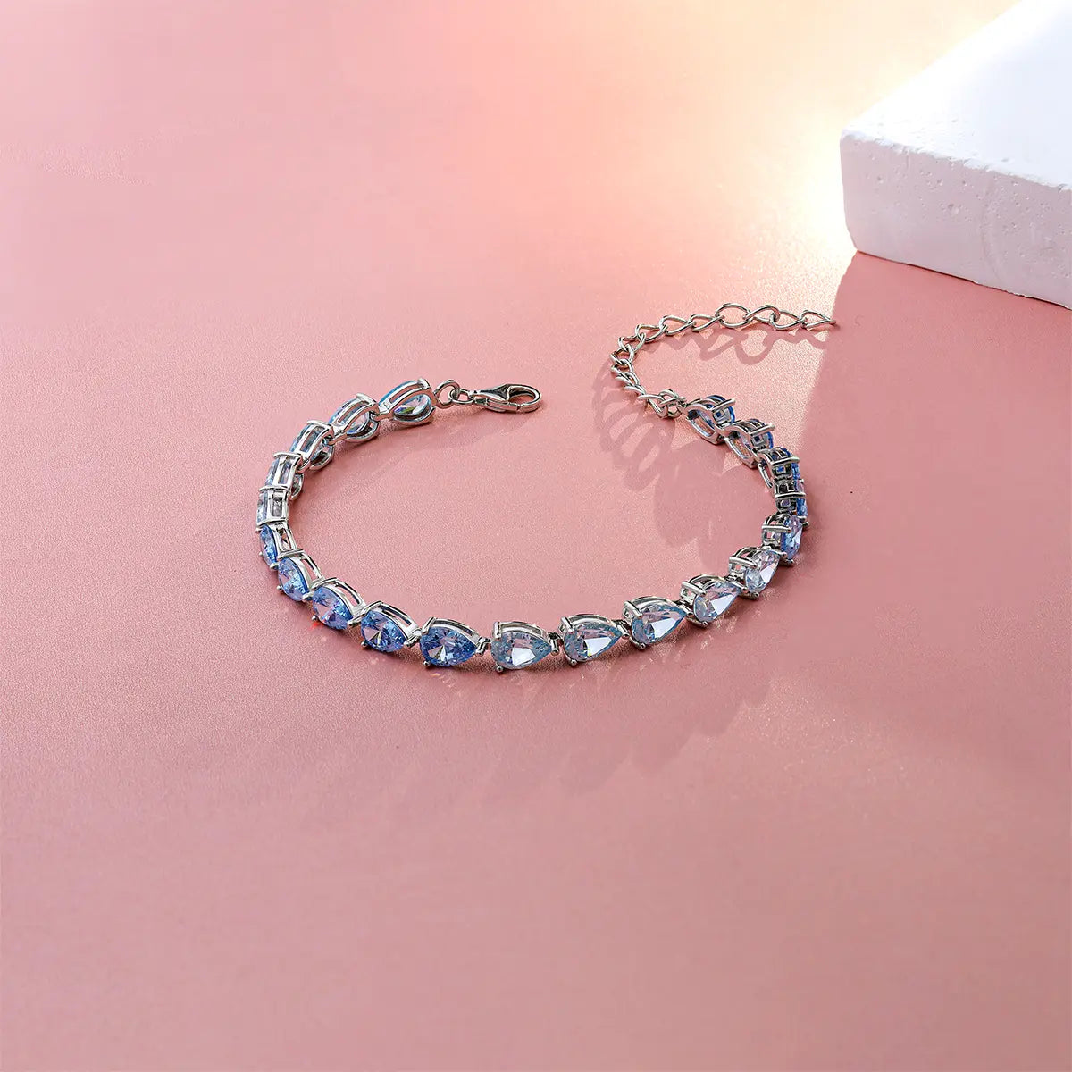 Blue gradient tennis bracelet with pear cut zirconia gemstones in sterling silver