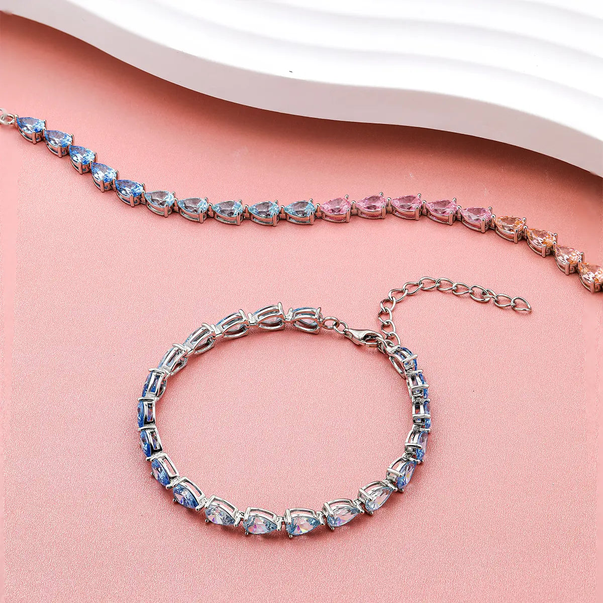Blue gradient tennis bracelet with pear cut zirconia gemstones in sterling silver