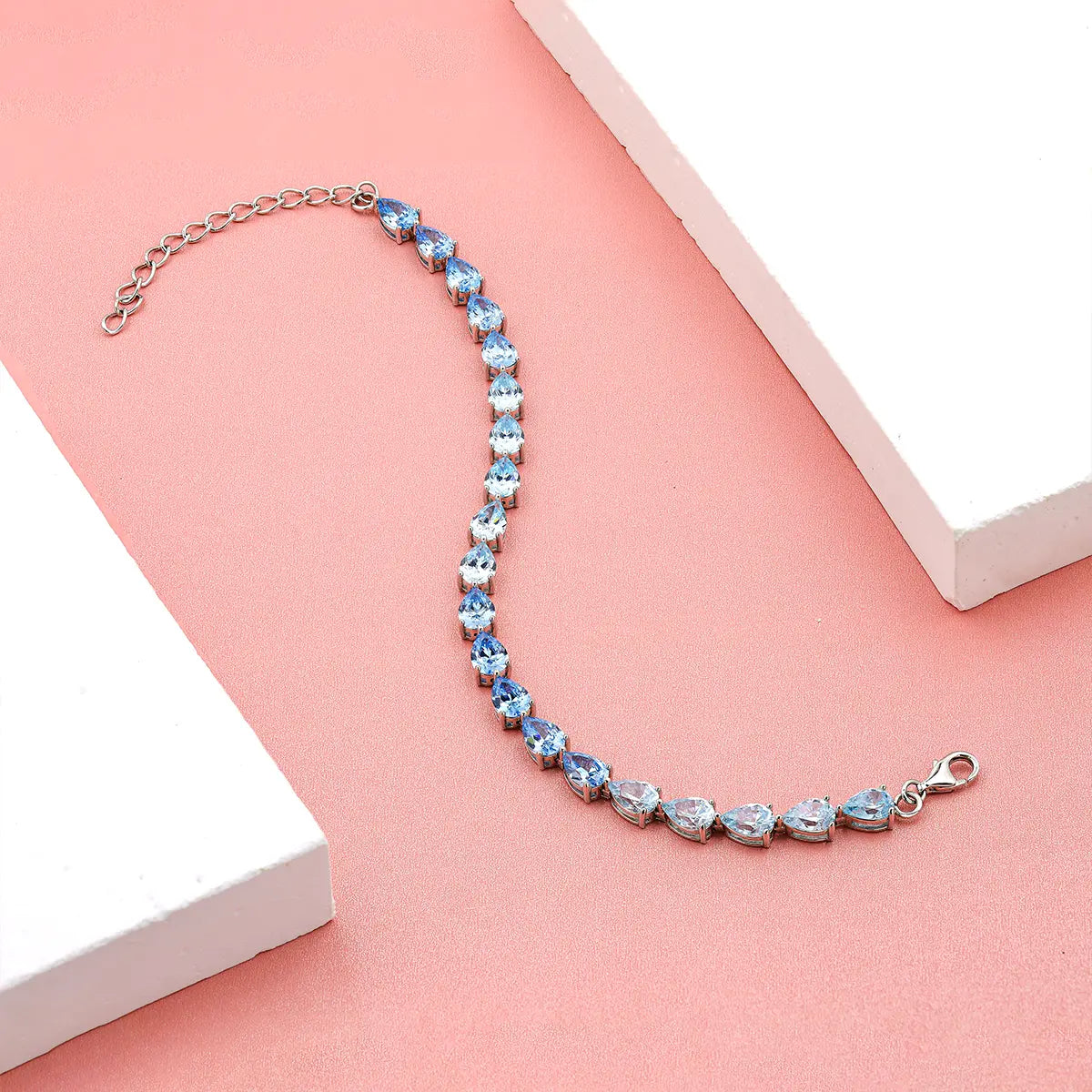 Blue gradient tennis bracelet with pear cut zirconia gemstones in sterling silver