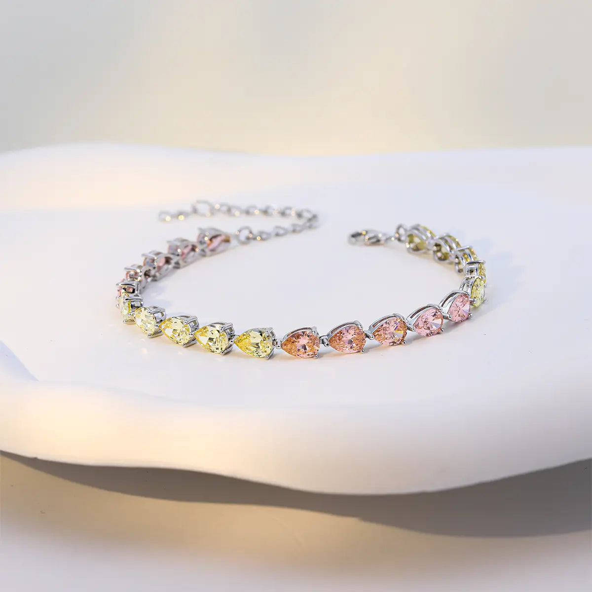 Modern sterling silver tennis bracelet with pear cut multicolor zirconia gems