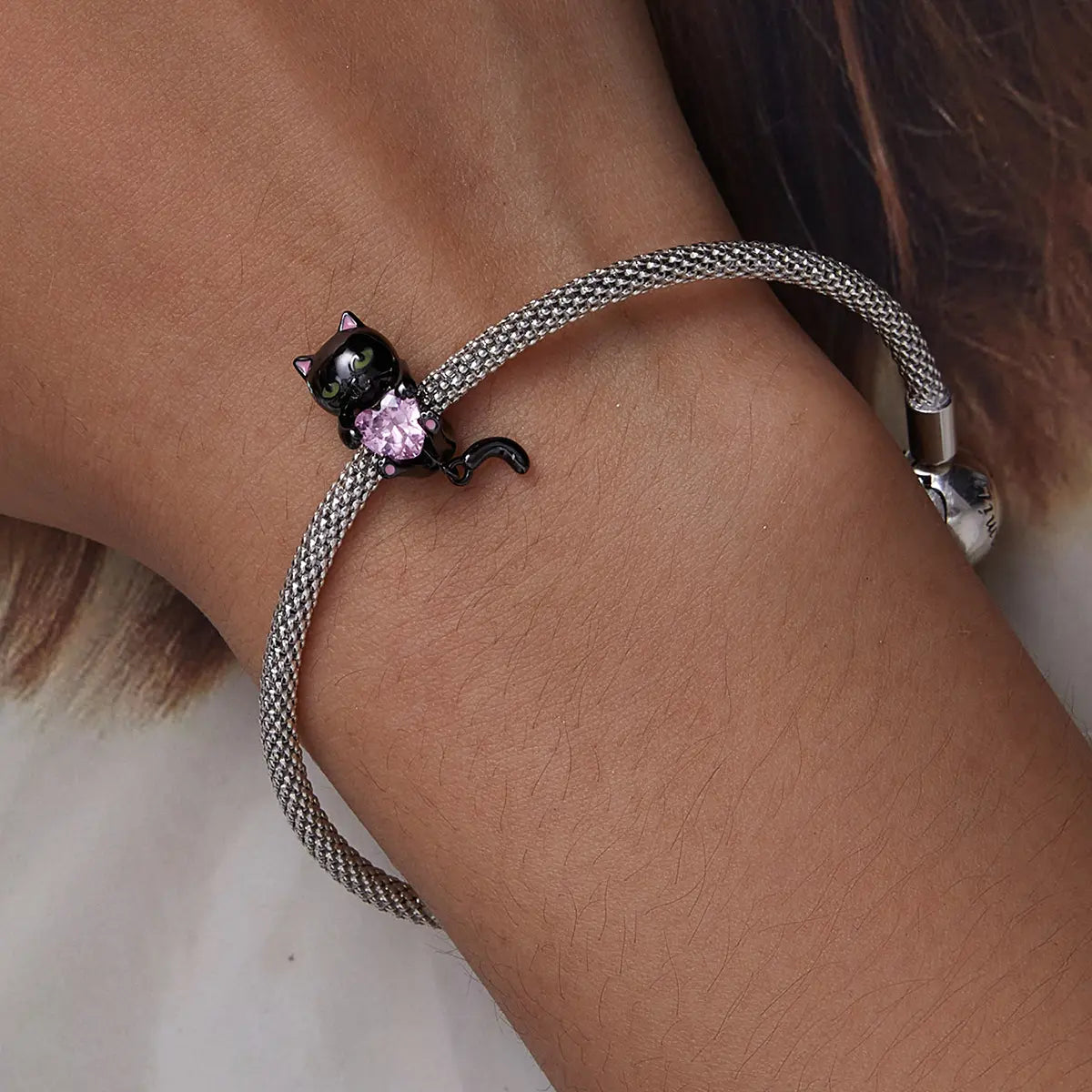 Black cat charm bracelet with enamel detail and cubic zirconia, crafted in sterling silver with black gold plating for Halloween style