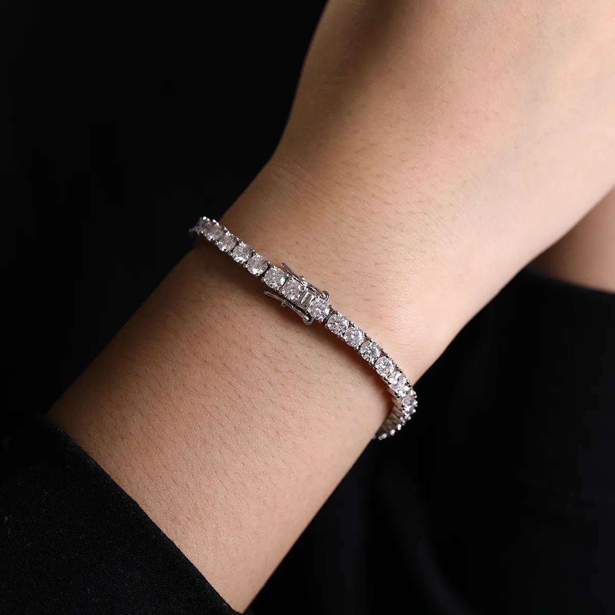 Round Moissanite Infinity Bracelet in 925 sterling silver with 18K white gold plating, featuring prong-set moissanites and an infinity-shaped clasp symbolizing eternity.