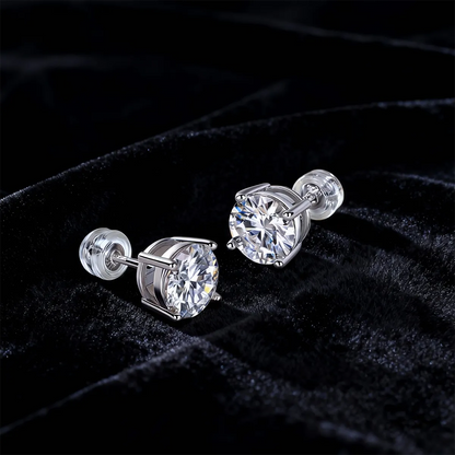 Round cut moissanite stud earrings in four-prong sterling silver setting, 6.5mm hypoallergenic design.