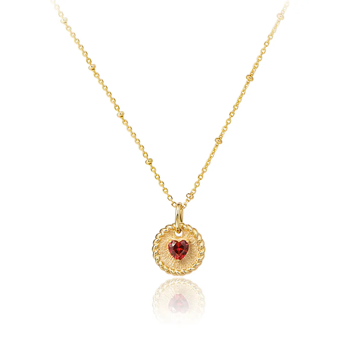 Elegant ruby double-heart necklace with brushed gold disc and starlit bead chain