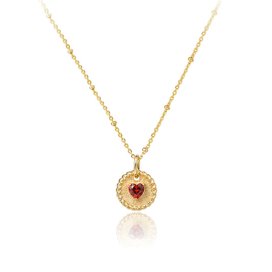 Elegant ruby double-heart necklace with brushed gold disc and starlit bead chain
