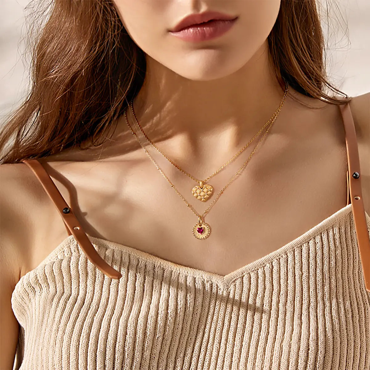 Elegant ruby double-heart necklace with brushed gold disc and starlit bead chain