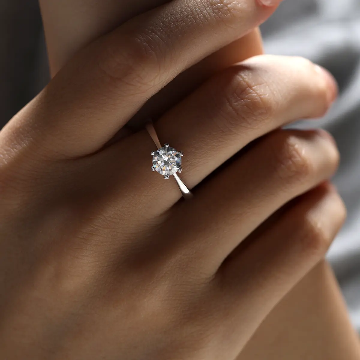 1ct round moissanite six-prong engagement ring in 925 silver with 18K white gold plating, heart-shaped prongs