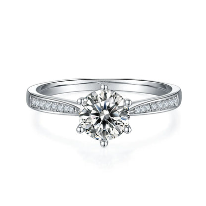 1ct Round Moissanite Heart-Prong Pave Ring in 925 Sterling Silver with 18K White Gold Plating, featuring heart-shaped six prongs and sparkling pave band.