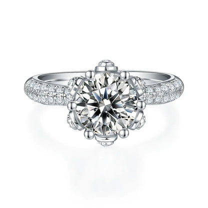 Elegant floral halo ring featuring a 2ct round moissanite and double side stones.