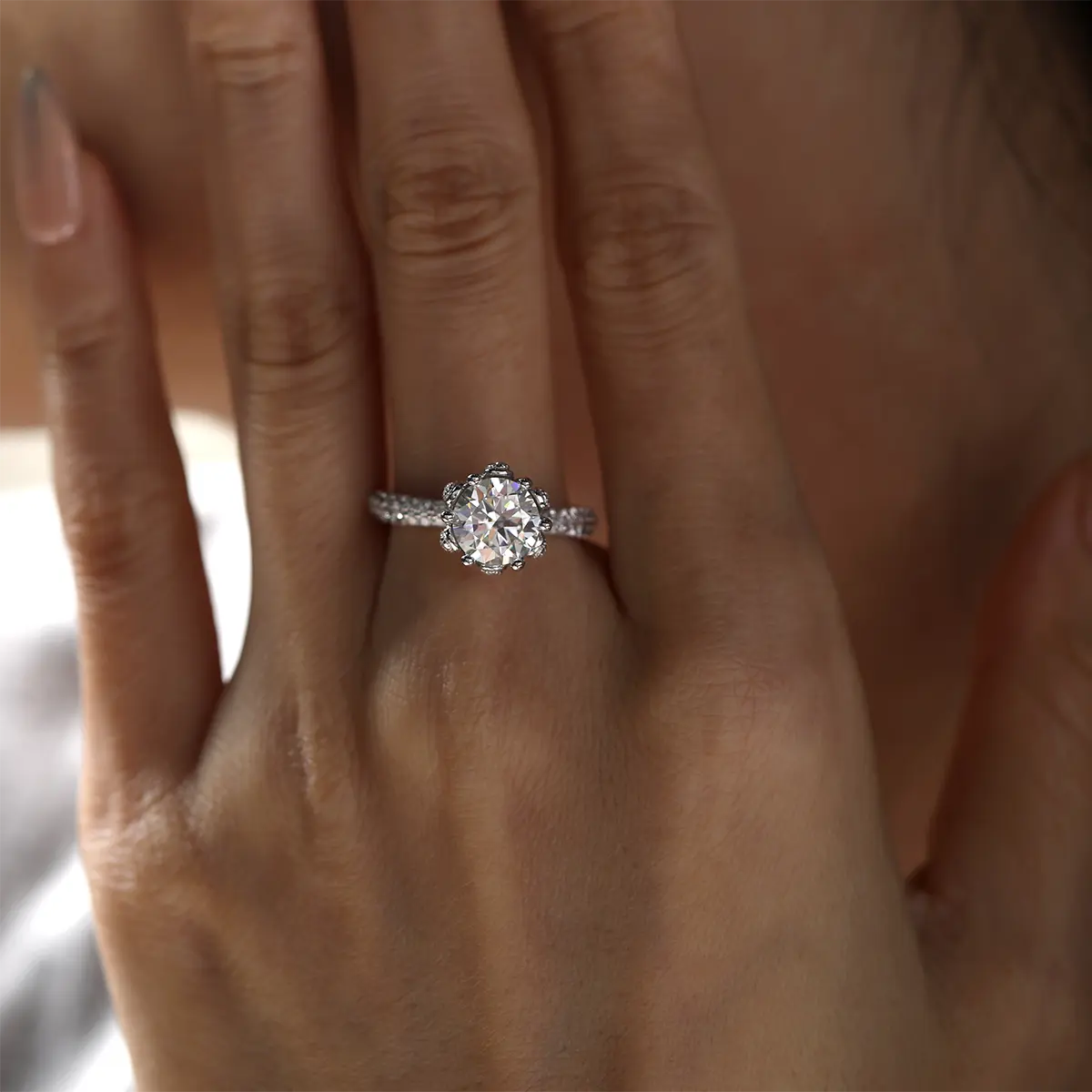 Elegant floral halo ring featuring a 2ct round moissanite and double side stones.