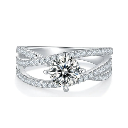 silver moissanite ring with 1ct round center stone and double-row crossover pavé band