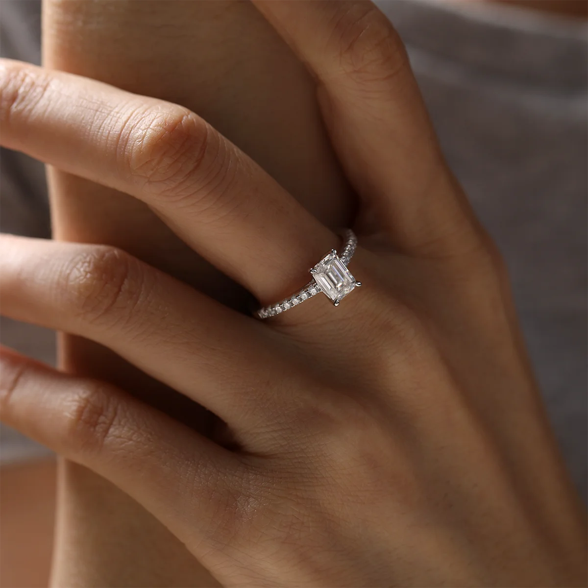 elegant emerald cut moissanite engagement ring with pavé accents, silver setting