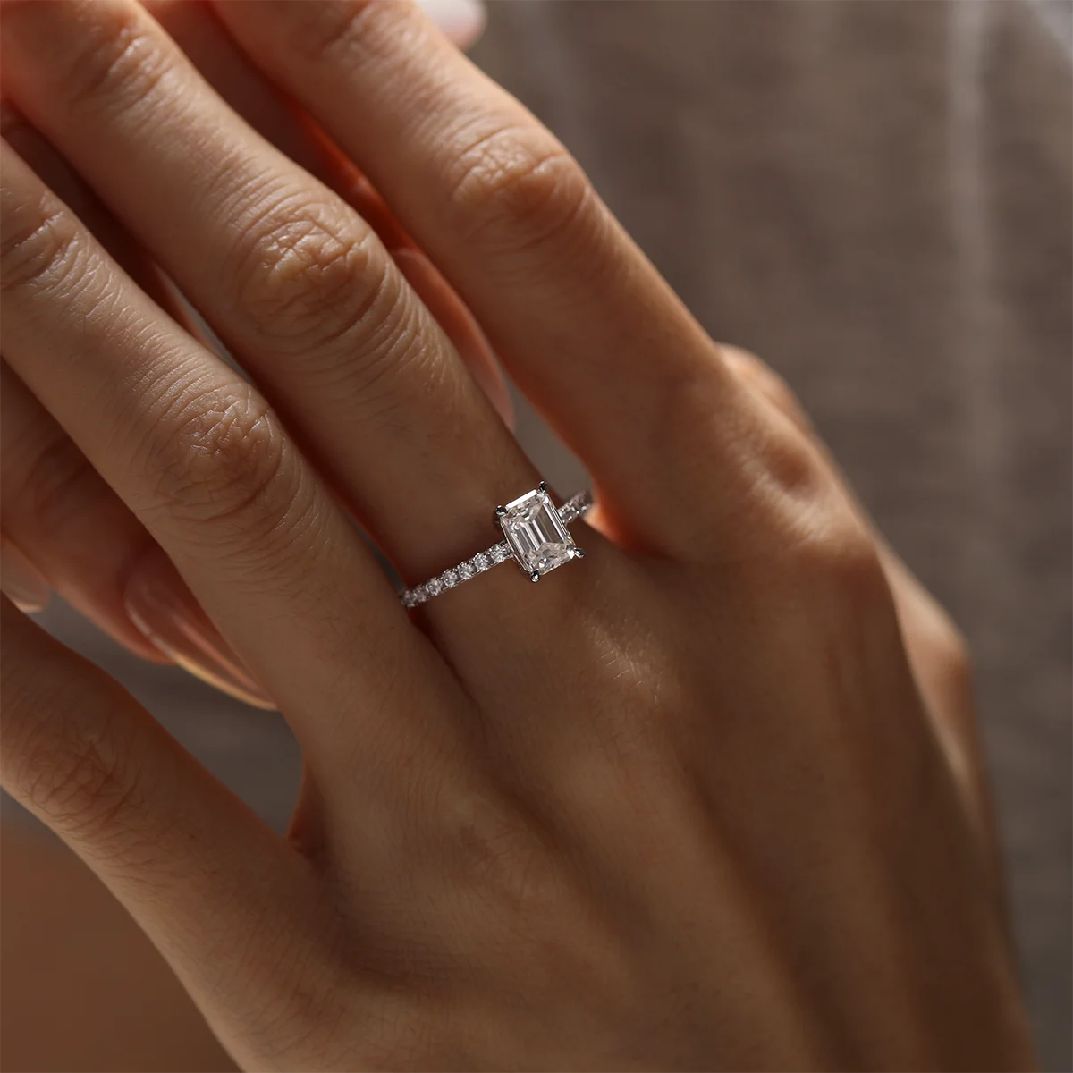 elegant emerald cut moissanite engagement ring with pavé accents, silver setting