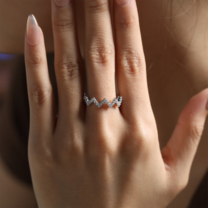 0.7ct Moissanite Geometric Band Ring in 925 Sterling Silver with 18K White Gold Plating, featuring modern folded-line design and sparkling moissanites.