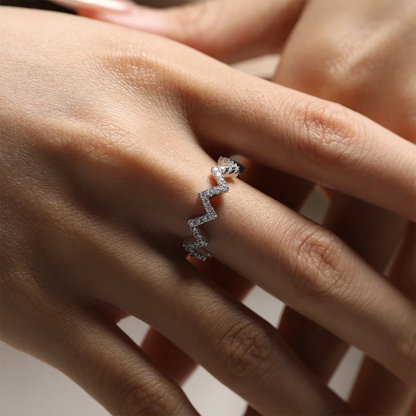0.7ct Moissanite Geometric Band Ring in 925 Sterling Silver with 18K White Gold Plating, featuring modern folded-line design and sparkling moissanites.