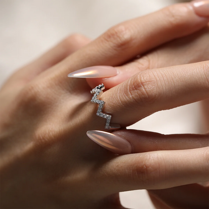 0.7ct Moissanite Geometric Band Ring in 925 Sterling Silver with 18K White Gold Plating, featuring modern folded-line design and sparkling moissanites.
