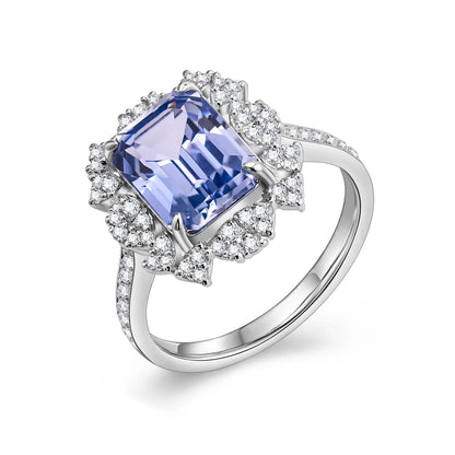 Sterling silver ring set with a 10×8mm, approx. 5.5ct emerald-cut cornflower blue sapphire and white cubic zirconia accents, inspired by a night-sky–themed design.
