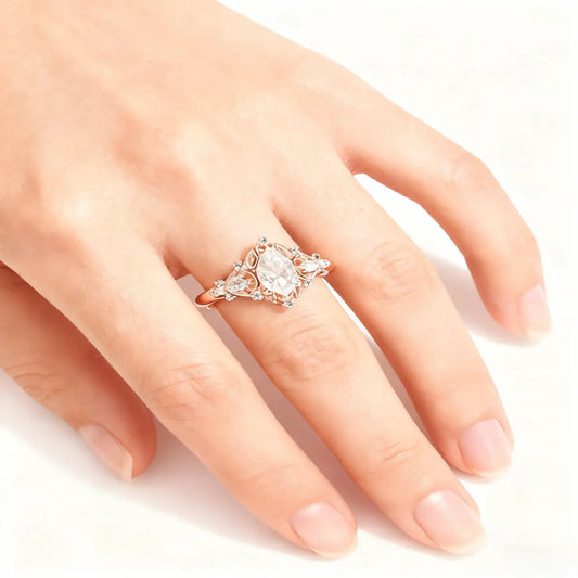 Victorian style rose gold cluster ring with pear cut center diamond and pear accents