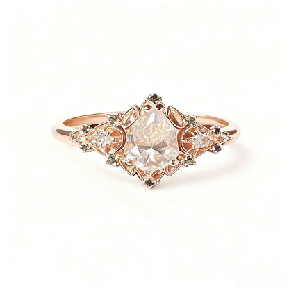 Victorian style rose gold cluster ring with pear cut center diamond and pear accents