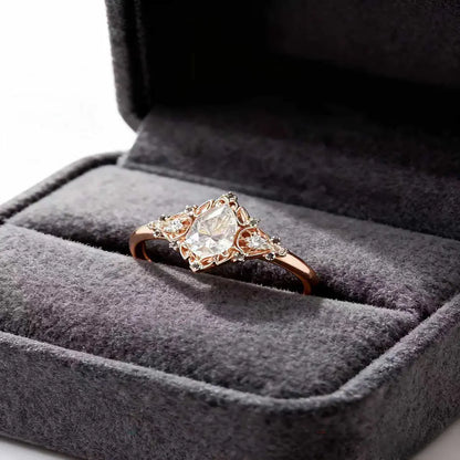 Victorian style rose gold cluster ring with pear cut center diamond and pear accents