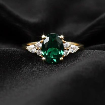 14K yellow gold ring with a 1.6ct oval-cut deep green lab-grown diamond and a slim classic band