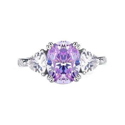 Luminous three-stone engagement ring with 1.8ct oval purple diamond center and pear-shaped white diamond side stones on 14K white gold band