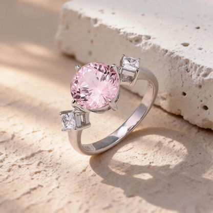 3.55ct round lab-grown Padparadscha sapphire three-stone ring in 925 sterling silver with cubic zirconia side stones, pink peach center stone approx 9mm