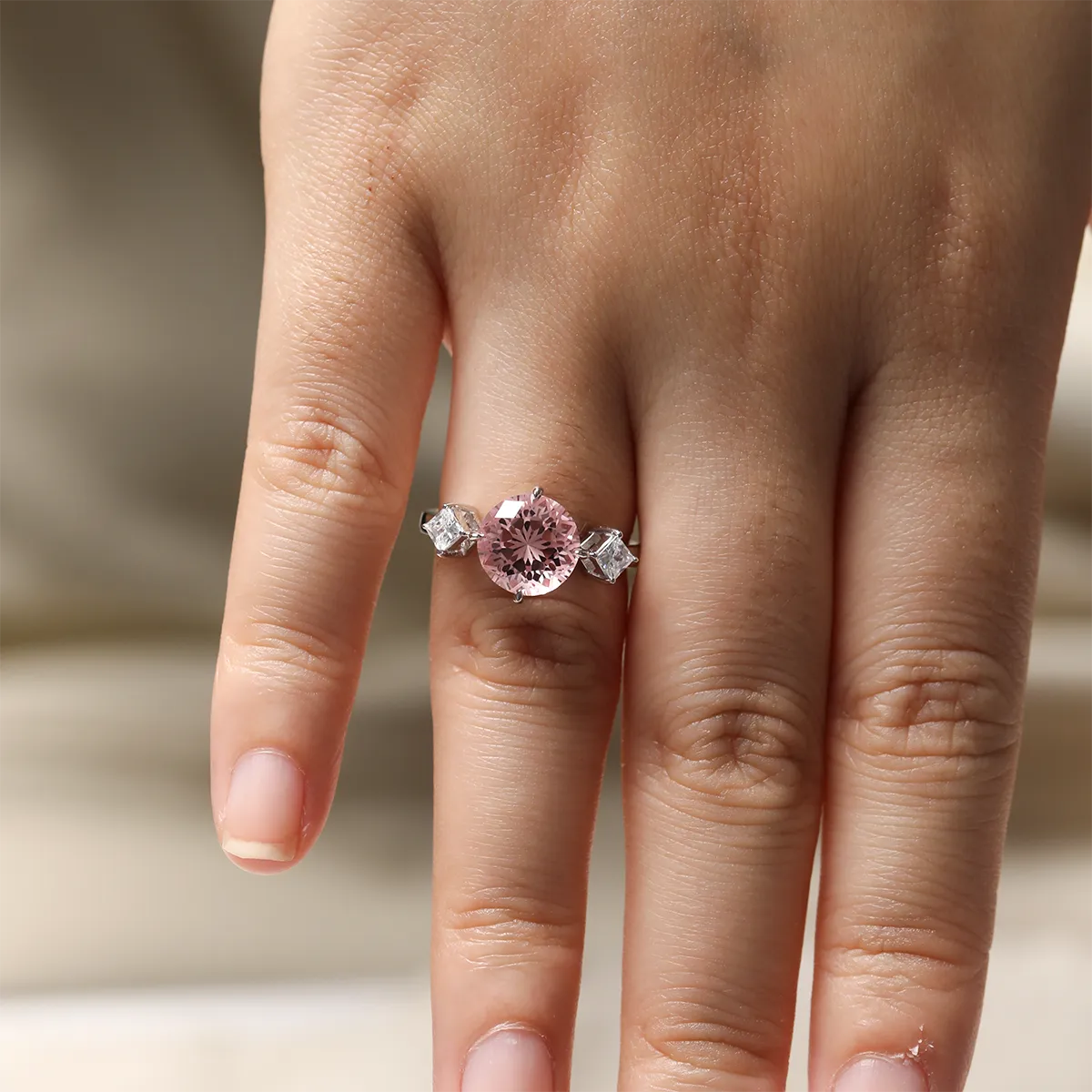 3.55ct round lab-grown Padparadscha sapphire three-stone ring in 925 sterling silver with cubic zirconia side stones, pink peach center stone approx 9mm