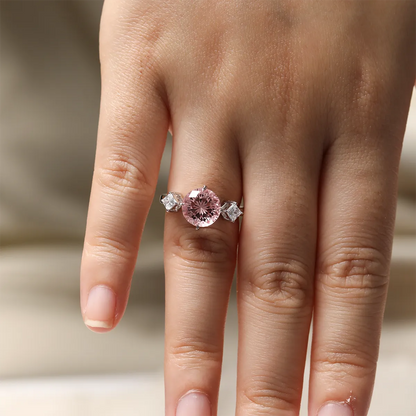 3.55ct round lab-grown Padparadscha sapphire three-stone ring in 925 sterling silver with cubic zirconia side stones, pink peach center stone approx 9mm