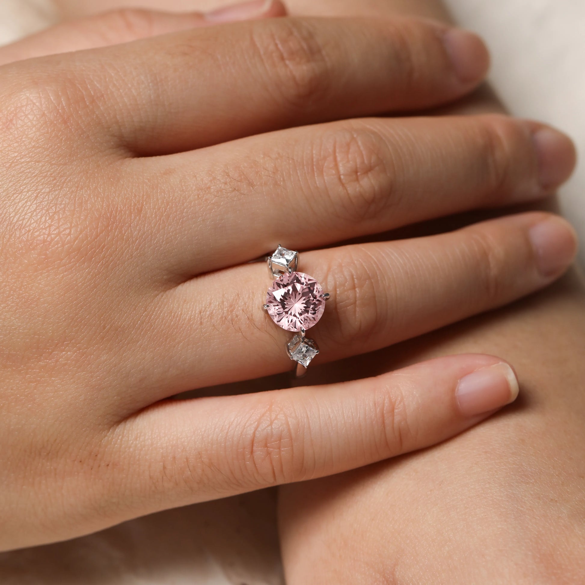 3.55ct round lab-grown Padparadscha sapphire three-stone ring in 925 sterling silver with cubic zirconia side stones, pink peach center stone approx 9mm